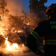 A firefighter battles a blaze in Zaton, Croatia, on Wednesday, July 13, 2022.
